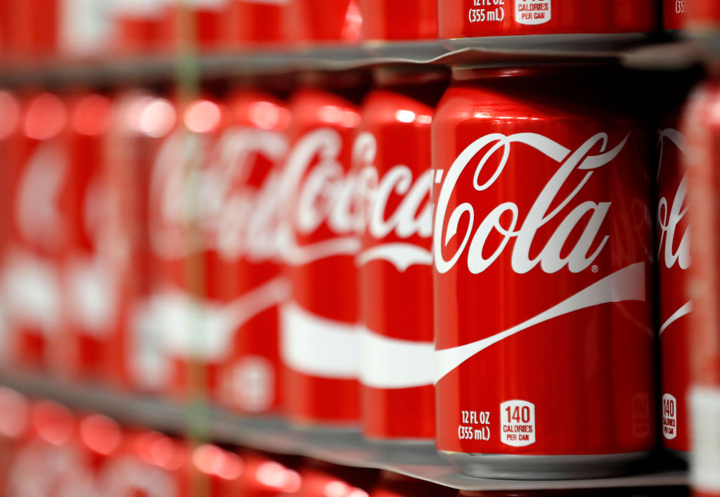 Cans of Coca-Cola on a store shelf