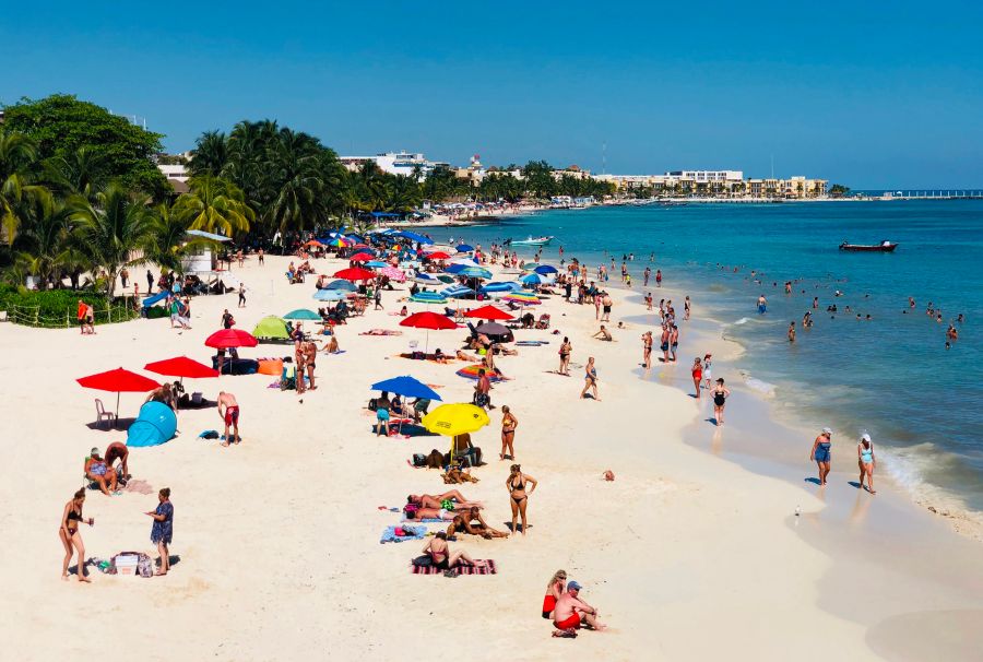 People enjoy a day on the beach in Playa del Carmen, Mexico.