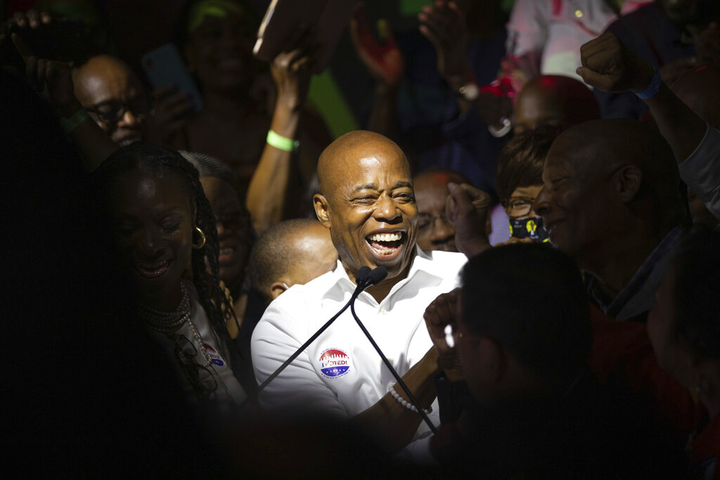 Mayoral candidate Eric Adams mingles with supporters during his election night party. The error had indicated that Adams, a former police captain who would be the city’s second Black mayor, had lost much of his lead and was ahead of former sanitation commissioner Kathryn Garcia by fewer than 16,000 votes. (AP Photo/Kevin Hagen)