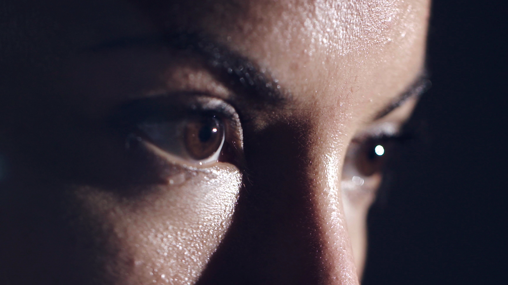 Closeup of woman's eyes as she sweats