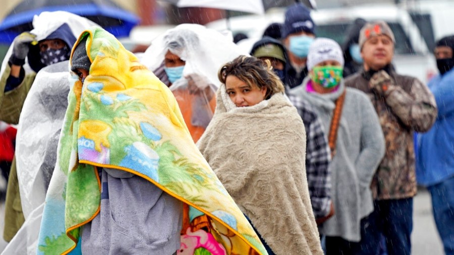 People wait in line to fill propane tanks Wednesday, Feb. 17, 2021, in Houston. Customers waited over an hour in the freezing rain to fill their tanks. Millions in Texas still had no power after a historic snowfall and single-digit temperatures created a surge of demand for electricity to warm up homes unaccustomed to such extreme lows, buckling the state's power grid and causing widespread blackouts. (AP Photo/David J. Phillip)