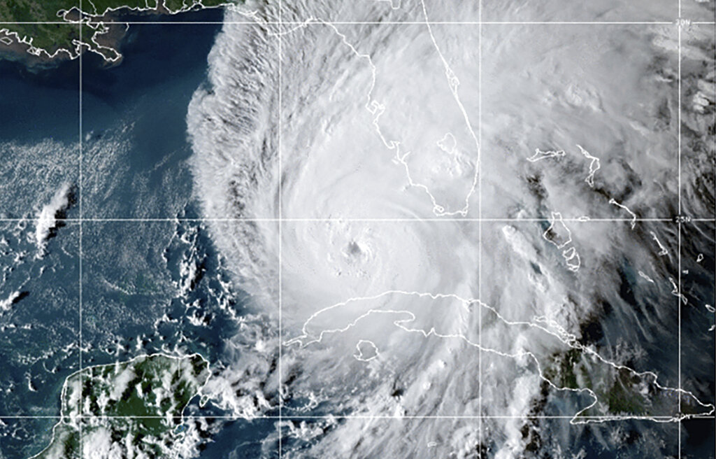 This GOES-East GeoCcolor satellite image taken at 10:10 p.m. EDT on Tuesday, Sept. 27, 2022, and provided by the National Oceanic and Atmospheric Administration (NOAA), shows Hurricane Ian over the Gulf of Mexico. Ian tore into western Cuba as a major hurricane Tuesday, knocking out power to the entire country and leaving millions people without electricity, before churning on a collision course with Florida over warm Gulf waters amid expectations it would strengthen into a catastrophic Category 4 storm. (NOAA via AP)