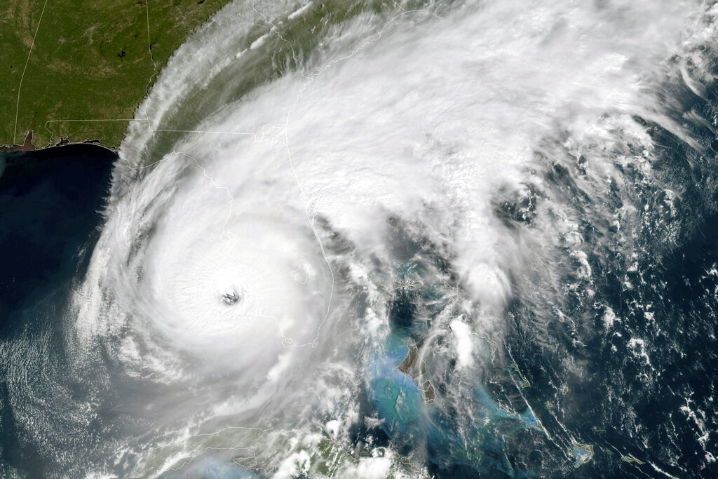 This GOES-East GeoColor satellite image taken at 12:01 a.m. EDT on Wednesday, Sept. 18, 2022, and provided by the National Oceanic and Atmospheric Administration (NOAA), shows the eye of Hurricane Ian approaching the southwest coast of Florida. Hurricane Ian's most damaging winds began hitting Florida's southwest coast Wednesday, lashing the state with heavy rain and pushing a devastating storm surge after strengthening to the threshold of the most dangerous Category 5 status. (NOAA via AP)