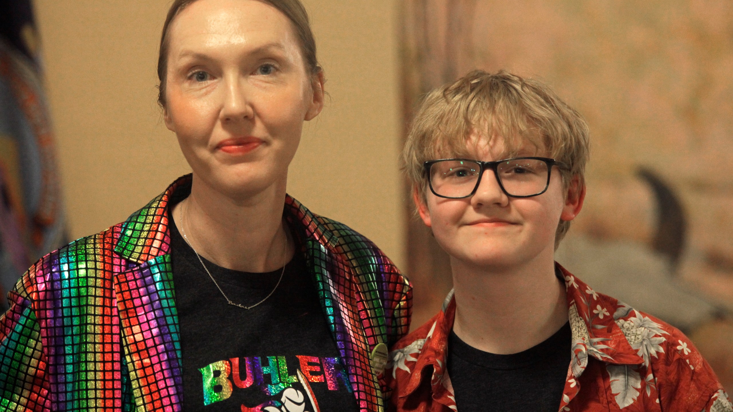 Cat Poland, of Buhler, Kansas, poses with her 13-year-old trans son, Alex, after a day of lobbying by LGBTQ youth and their advocates at the Statehouse, Tuesday, March 28, 2023, in Topeka, Kan. Alex runs cross country and hopes to play baseball next year, and he and his mother are frustrated with multiple bills seeking to roll back LGBTQ rights in the Kansas Legislature, including one to ban transgender athletes from girls' and women's sports. (AP Photo/John Hanna)