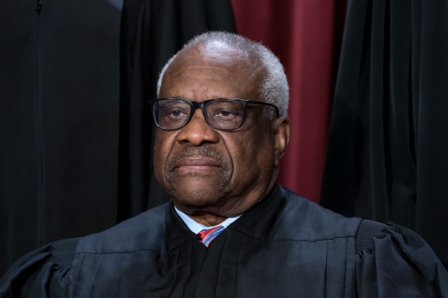 FILE - Associate Justice Clarence Thomas joins other members of the Supreme Court as they pose for a new group portrait, at the Supreme Court building in Washington, Oct. 7, 2022. Thomas said Friday, April 7, that he was not required to disclose the many trips he and his wife took that were paid for by Republican megadonor Harlan Crow. The nonprofit investigative journalism organization ProPublica reported Thursday that Thomas, who has been a justice for more than 31 years, has for more than two decades accepted luxury trips from Crow nearly every year.(AP Photo/J. Scott Applewhite, File)