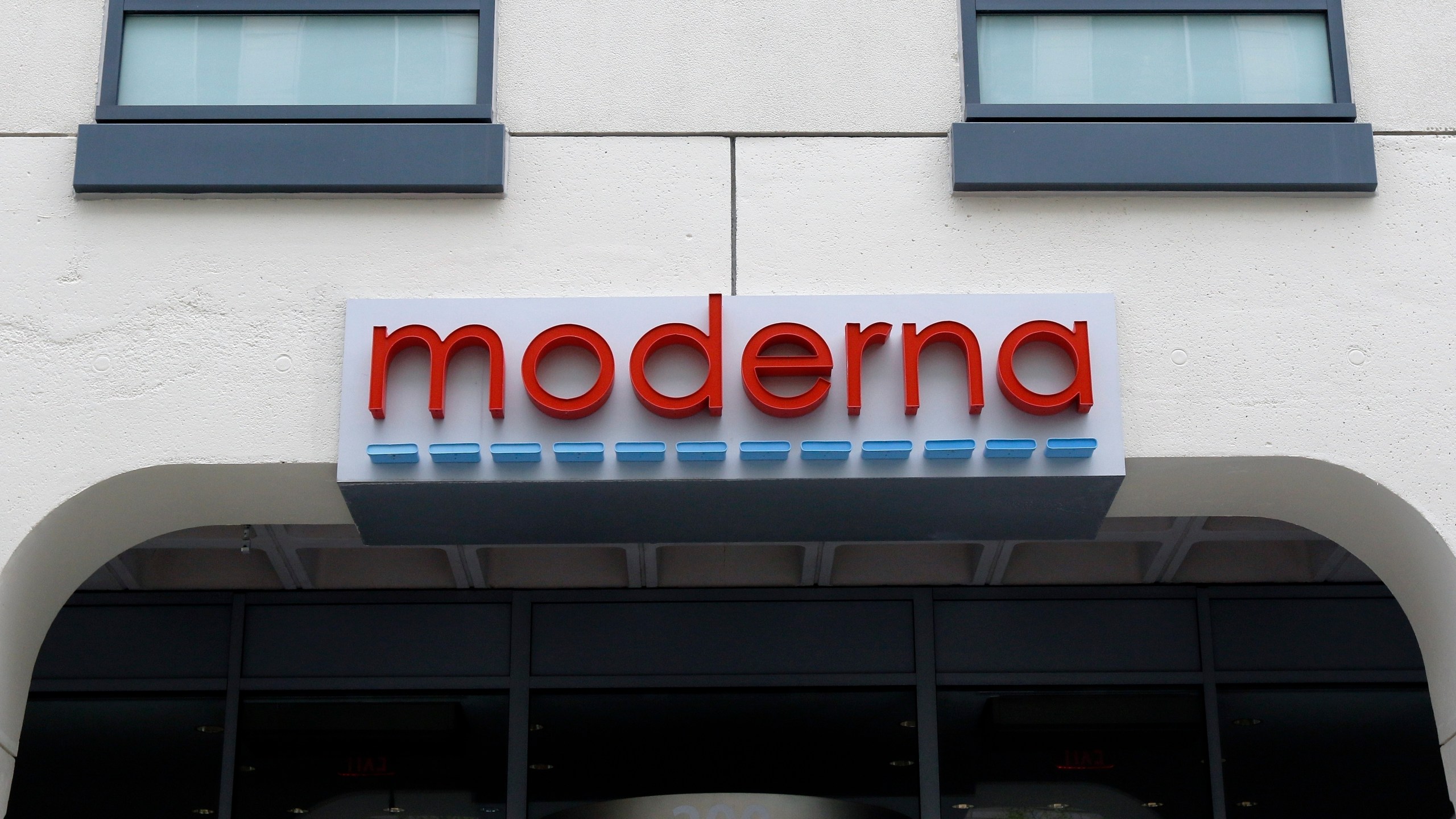 FILE - A sign marks an entrance to a Moderna building in Cambridge, Mass., on Monday, May 18, 2020. Moderna shares slipped Tuesday, April 11, 2023, after the COVID-19 vaccine developer said its potential flu vaccine needs more study in a late-stage clinical trial. (AP Photo/Bill Sikes, File)