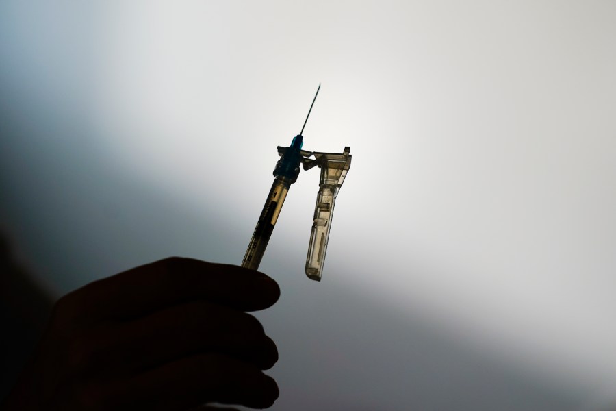 FILE - A syringe is prepared at a clinic in Norristown, Pa., Dec. 7, 2021. The Environmental Protection Agency proposed Tuesday, April 11, 2023, to limit the use of the chemical ethylene oxide after finding higher than expected cancer risk at facilities that use it to sterilize billions of medical devices each year. (AP Photo/Matt Rourke, File)