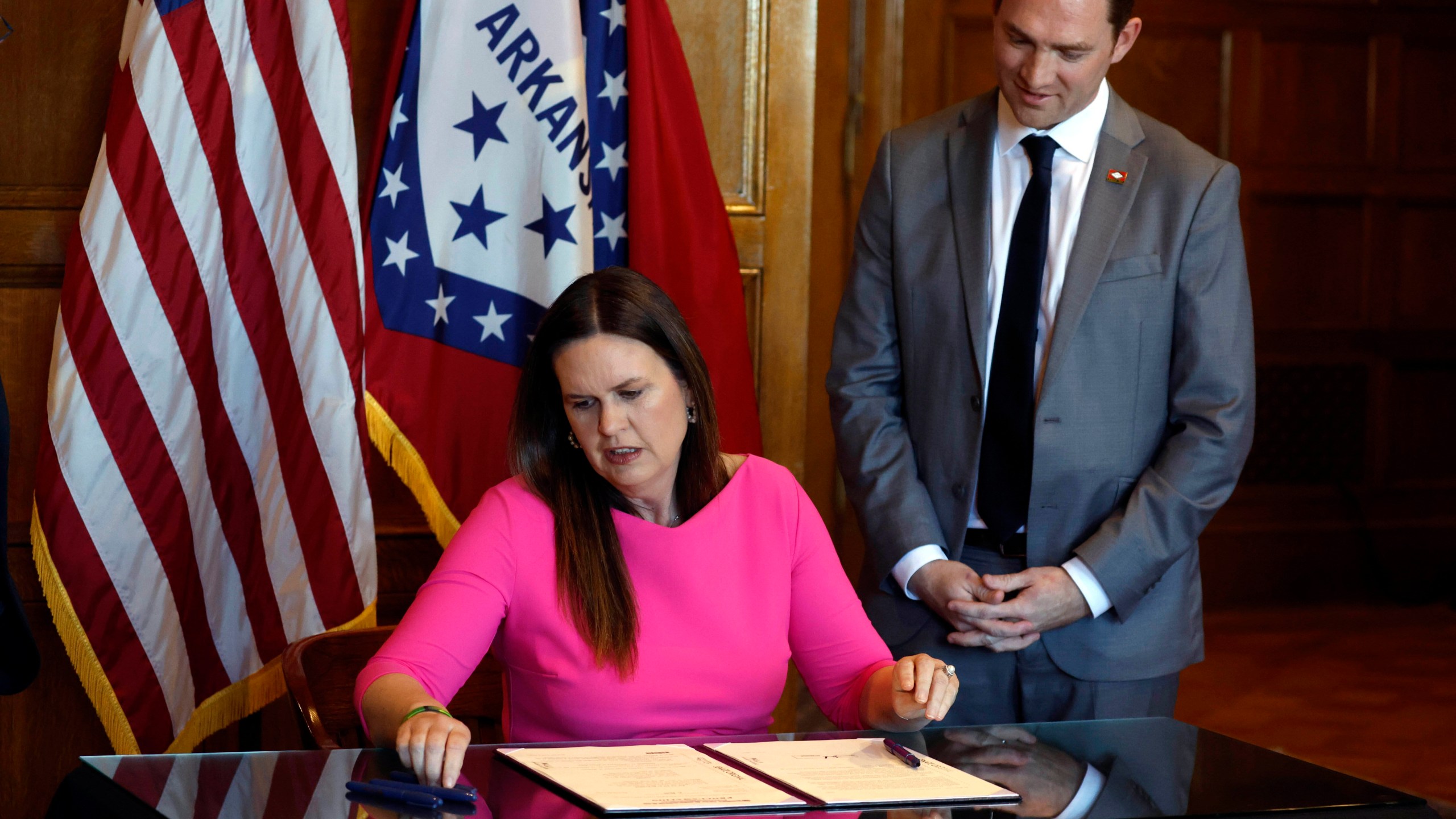 Gov. Sarah Huckabee Sanders signs a bill requiring age verification before creating a new social media account as Sen. Tyler Dees, R-Siloam Springs, looks on during a signing ceremony on Wednesday, April 12, 2023, at the state Capitol in Little Rock, Ark. (Thomas Metthe/Arkansas Democrat-Gazette via AP)