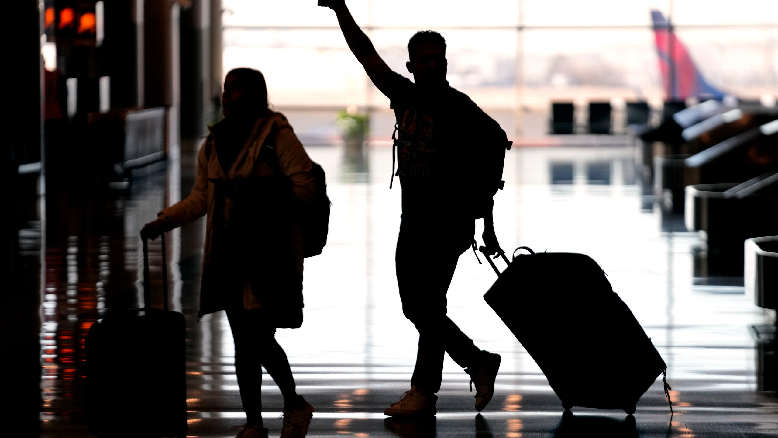 FILE - People pass through Salt Lake City International Airport on Jan. 11, 2023, in Salt Lake City. Federal officials said Thursday, April 13, 2023, that they have referred more than 250 unruly airline passengers to the FBI for possible criminal prosecution since late 2021, including one as recently as last month, when a man tried to stab a flight attendant with a broken-off spoon. (AP Photo/Rick Bowmer, File)