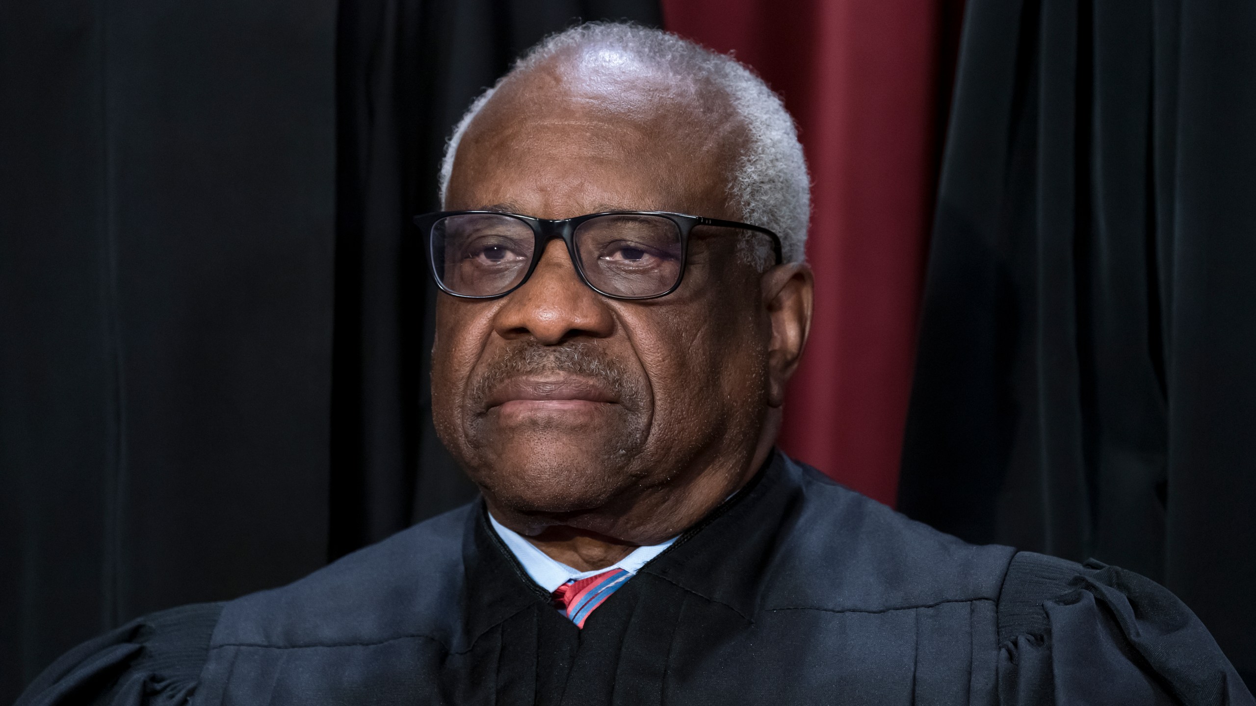 FILE - Associate Justice Clarence Thomas joins other members of the Supreme Court as they pose for a new group portrait, at the Supreme Court building in Washington, Oct. 7, 2022. Conservative mega-donor Harlan Crow purchased three properties belonging to Thomas and his family, in a transaction worth more than $100,000 that Thomas never reported, according to the non-profit investigative journalism organization ProPublica on Thursday, April 13, 2023. (AP Photo/J. Scott Applewhite, File)