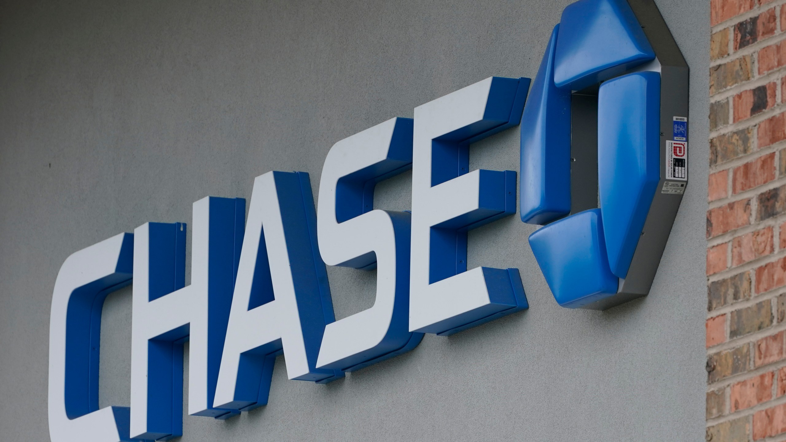 A Chase bank sign in Richmond, Va., Wednesday, June 2, 2021. PMorgan reports earnings on Friday, April 14, 2023. (AP Photo/Steve Helber, File)