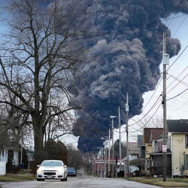 FILE - A black plume rises over East Palestine, Ohio, as a result of a controlled detonation of a portion of the derailed Norfolk Southern trains, on Feb. 6, 2023. Norfolk Southern CEO Alan Shaw is set to testify before an Ohio Senate rail safety panel on Tuesday, April 18, more than two months after the fiery train derailment rocked the village of East Palestine. (AP Photo/Gene J. Puskar, File)