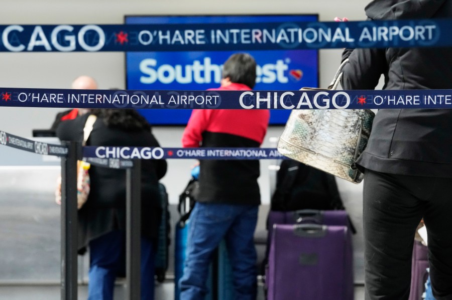 Travelers check in at a Southwest Airlines ticket counter at O'Hare International Airport in Chicago, Tuesday, April 18, 2023. Southwest Airlines planes were grounded nationwide for what the airline called an intermittent technology issue, causing more than 1,700 flight delays Tuesday just four months after the carrier suffered a meltdown over the Christmas travel rush. (AP Photo/Nam Y. Huh)