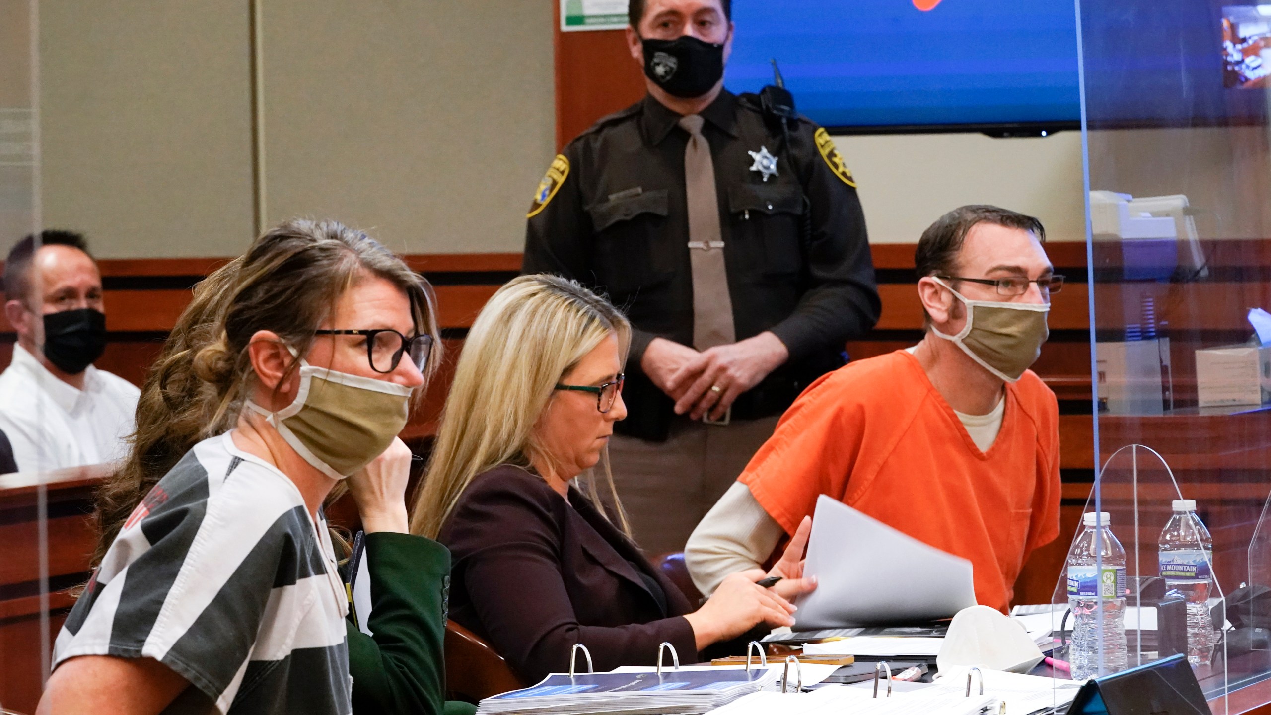 FILE - Jennifer Crumbley, left, and James Crumbley, right, the parents of Ethan Crumbley, a teenager accused of killing four students in a shooting at Oxford High School in Oxford, Mich., appear in court for a preliminary examination on involuntary manslaughter charges in Rochester Hills, Mich., Feb. 8, 2022. Criminal investigations of parents and school employees are rare following a school shooting, experts say. But they appear to be gaining traction as communities demand accountability and new ways to prevent the violence. (AP Photo/Paul Sancya, File)