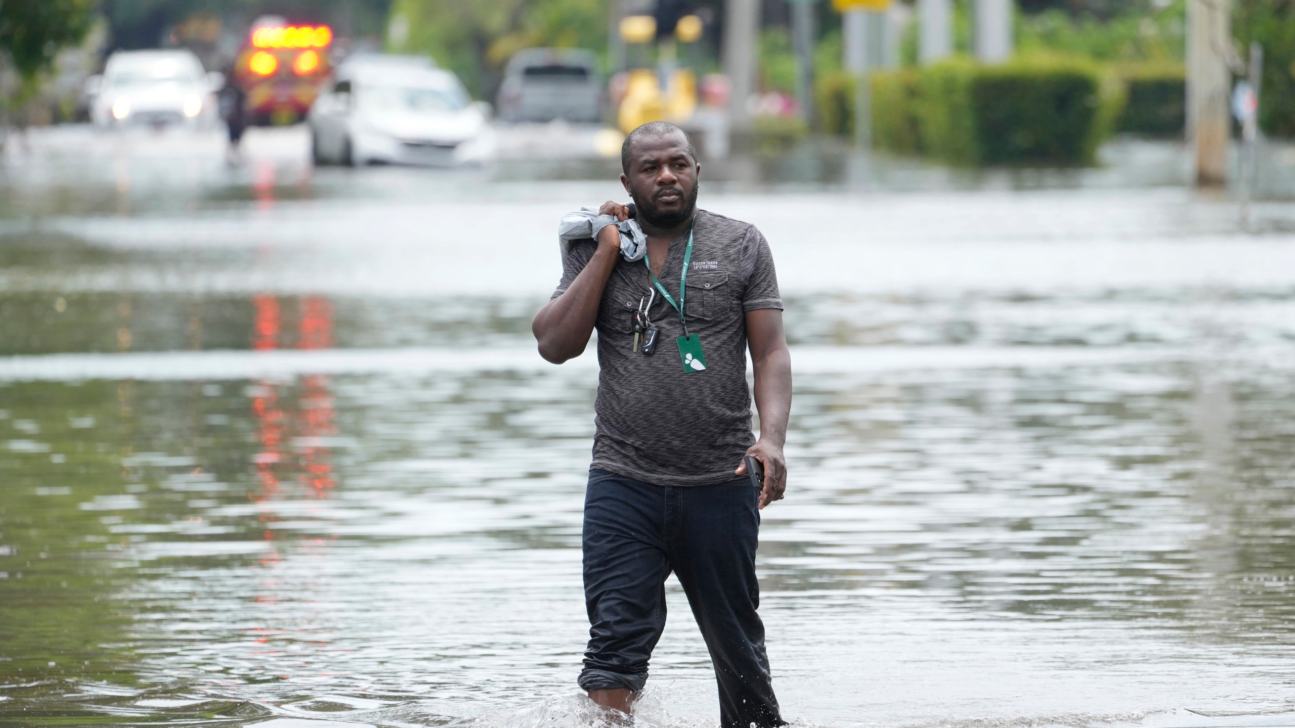 FILE - A man walks out of a flooded neighborhood Thursday, April 13, 2023, in Fort Lauderdale, Fla. Florida Gov. Ron DeSantis Saturday, April 22, 2023, is asking the Biden administration to declare Broward County a disaster area due to flooding earlier this month after record rainfall. (AP Photo/Marta Lavandier, File)