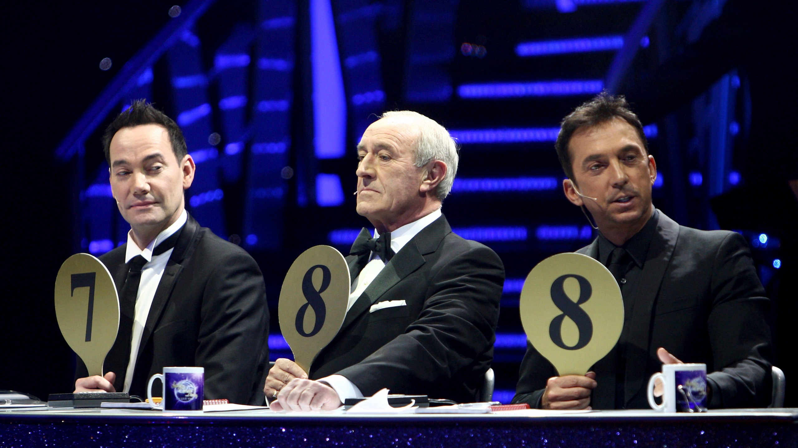 FILE - From left, judges Craig Revel Horwood, Len Goodman and Bruno Tonioli gesture, during the final dress rehearsal for the opening of the 'Strictly Come Dancing Live Tour' at the NIA, Birmingham, England, Jan. 20, 2012. Len Goodman, an urbane long-serving judge on “Dancing with the Stars” and “Strictly Come Dancing,” has died, his agent said Monday, April 24, 2023. He was 78. A former dancer, Goodman was a judge on “Strictly Come Dancing” for 12 years from its launch on the BBC in 2004. (David Jones/PA via AP, File)