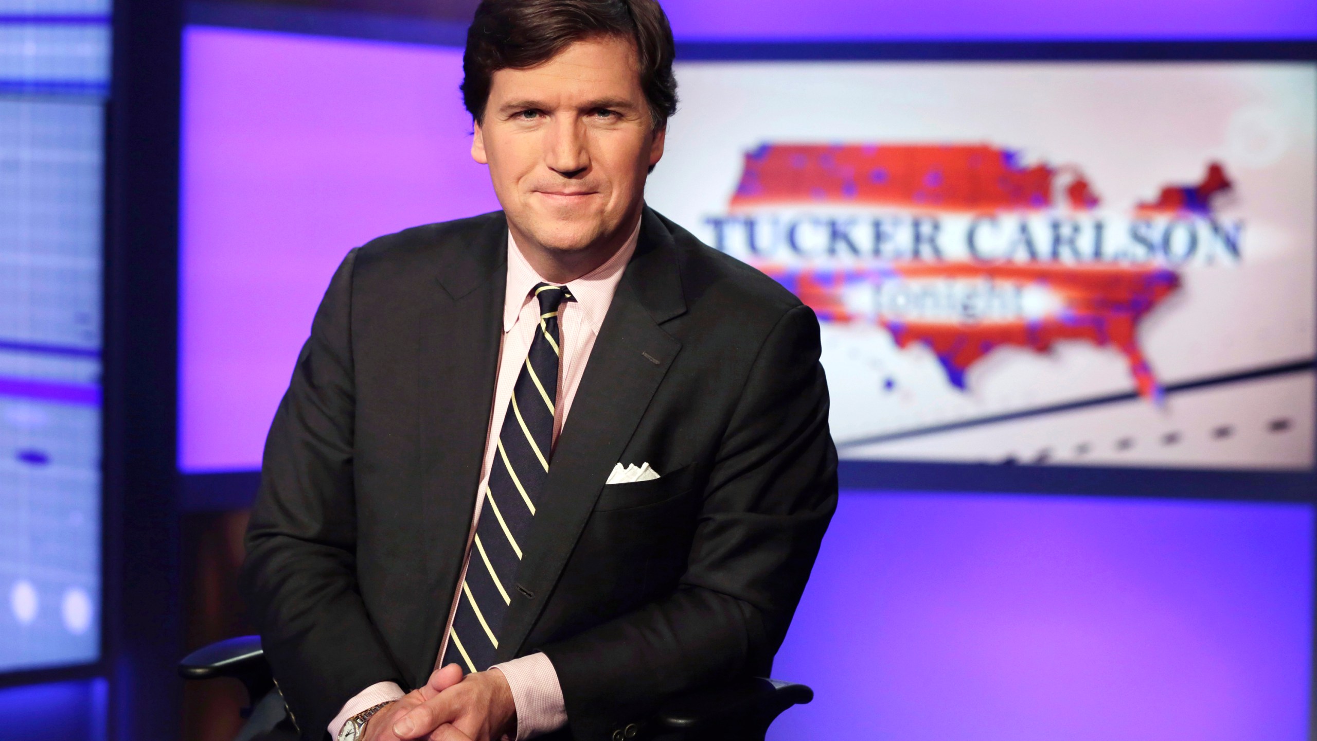 FILE - Tucker Carlson, host of "Tucker Carlson Tonight," poses for photos in a Fox News Channel studio on March 2, 2017, in New York. (AP Photo/Richard Drew, File)