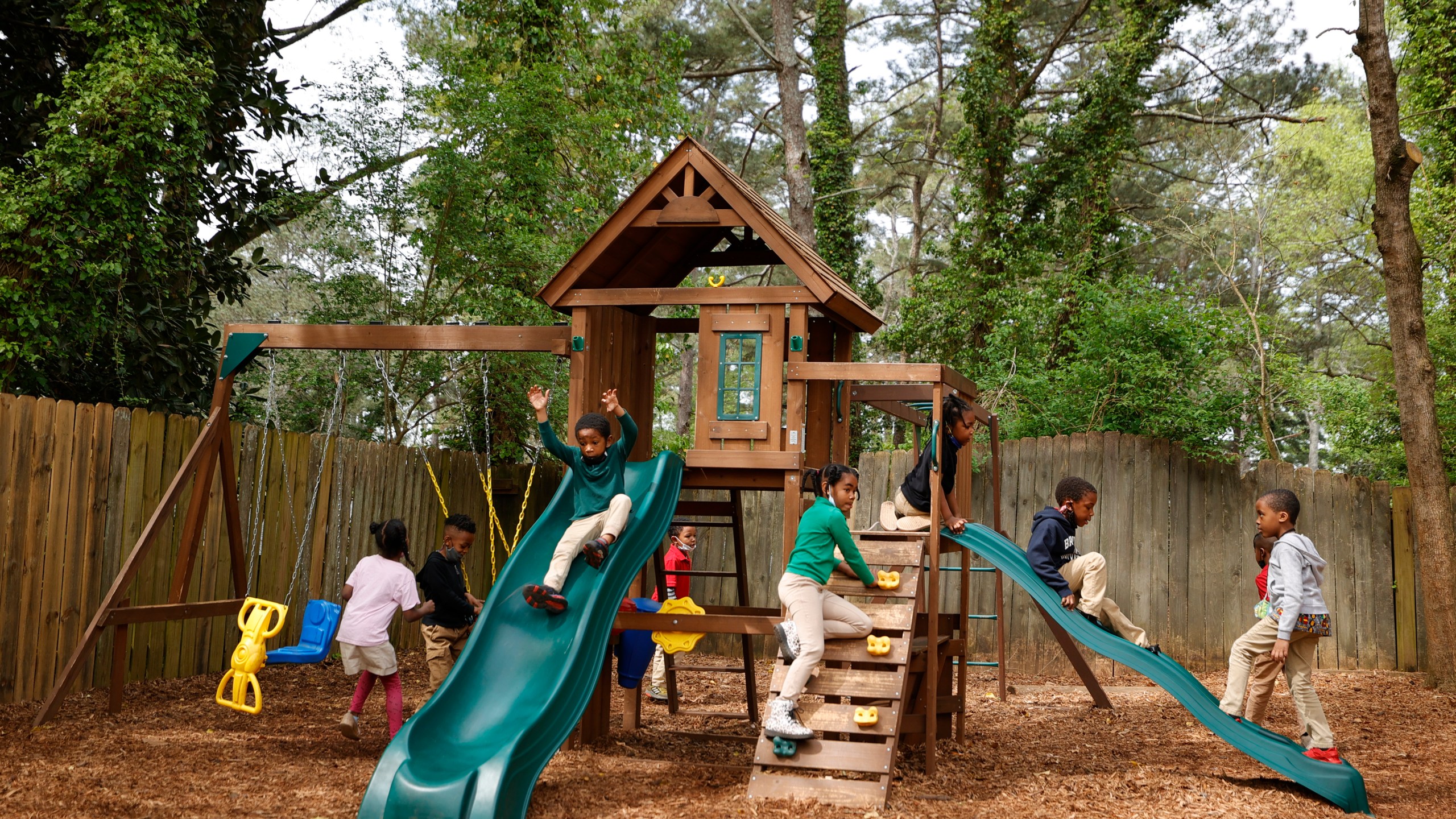 Students play on the playground at the Kilombo Academic and Cultural Institute, Tuesday, March 28, 2023, in Decatur, Ga. (AP Photo/Alex Slitz)