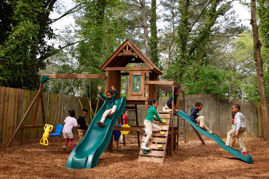 Students play on the playground at the Kilombo Academic and Cultural Institute, Tuesday, March 28, 2023, in Decatur, Ga. (AP Photo/Alex Slitz)