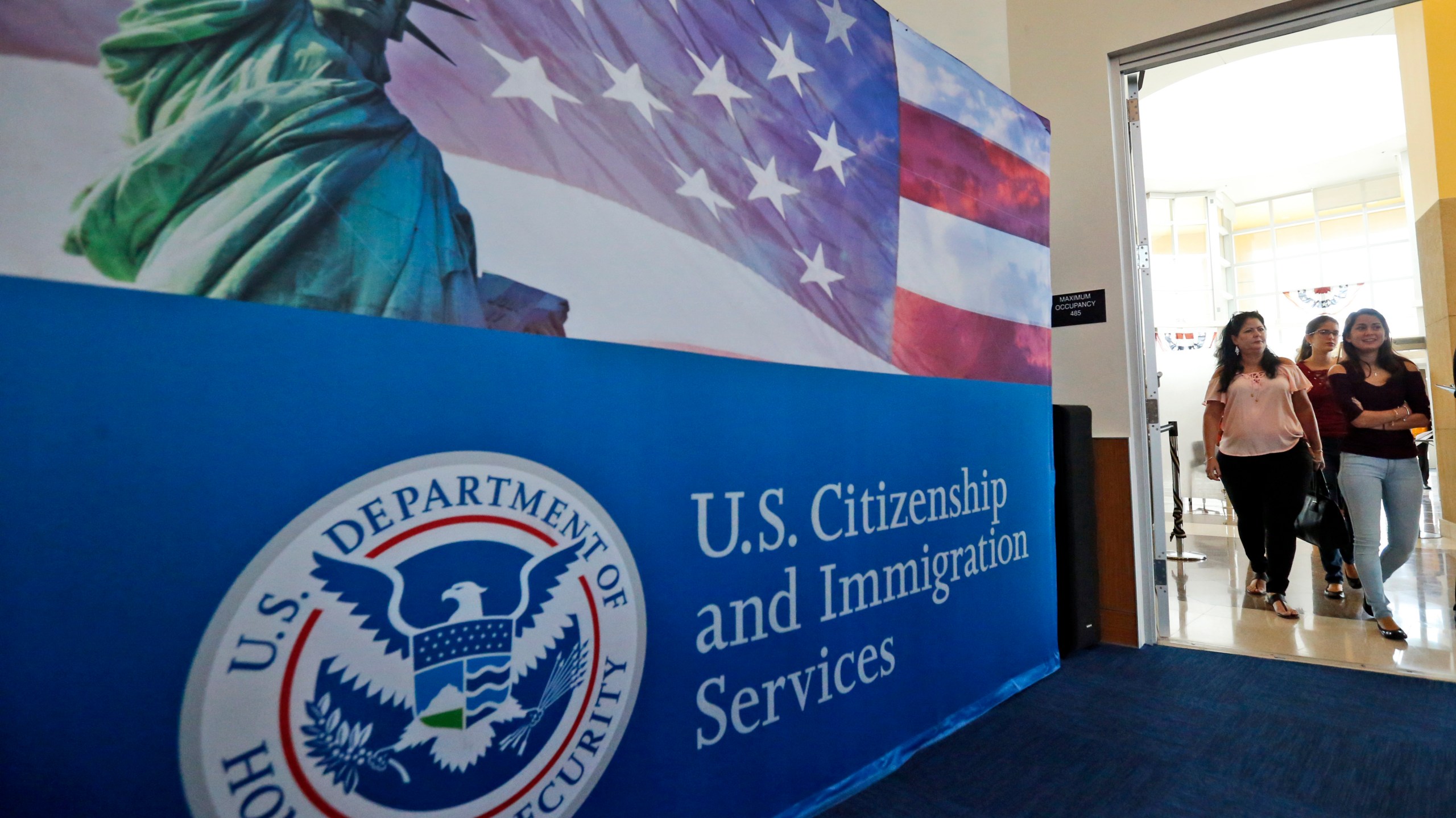 FILE - In this Aug. 17, 2018, file photo, people arrive before the start of a naturalization ceremony at the U.S. Citizenship and Immigration Services Miami Field Office in Miami. The number of applications for visas used in the technology industry soared for a second straight year, raising “serious concerns” that some are manipulating the system to gain an unfair advantage, authorities said Friday. There were 780,884 applications for H-1B visas in this year's computer-generated lottery, up 61% from 483,927 last year, U.S. Citizenship and Immigration Services said in a message to “stakeholders.” (AP Photo/Wilfredo Lee, File)