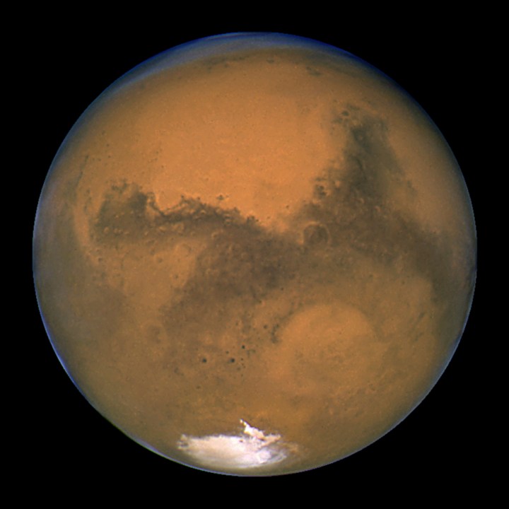 FILE - This Aug. 26, 2003, image made available by NASA shows Mars as it lines up with the Sun and the Earth. A new study suggests water on Mars may be more widespread and recent than previously thought. Scientists reported the finding from China's Mars rover in Science Advances on Friday, April 28, 2023. (NASA/J. Bell - Cornell U./M. Wolff - SSI via AP, File)