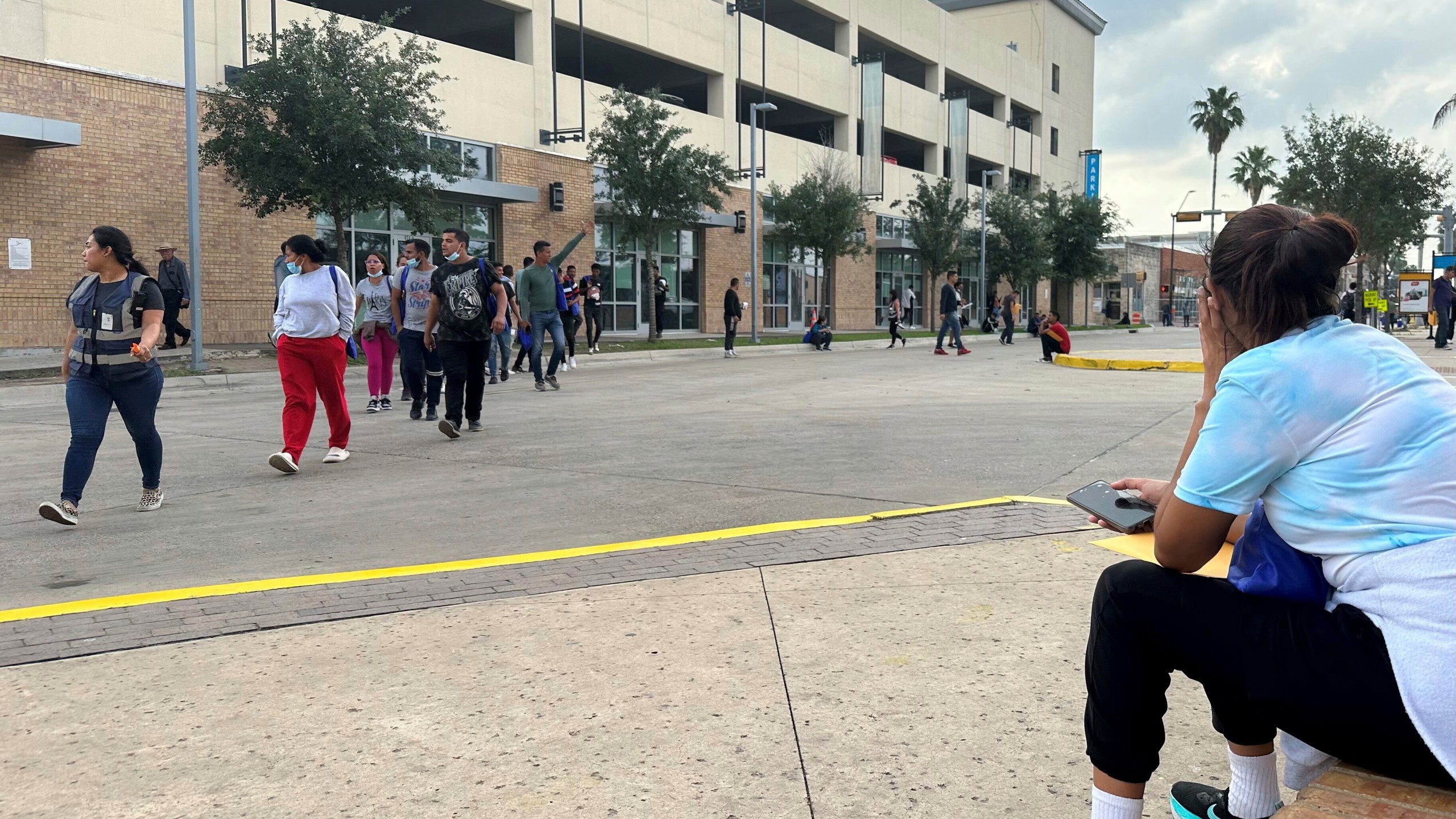 A group of people leave a welcome center for migrants in Brownsville, Texas, Friday, April 28, 2023. The city of Brownsville signed a disaster declaration after nearly 15,000 migrants crossed through the area, with many of them screened and released from federal custody and into the city. (AP Photo/Valerie Gonzalez)