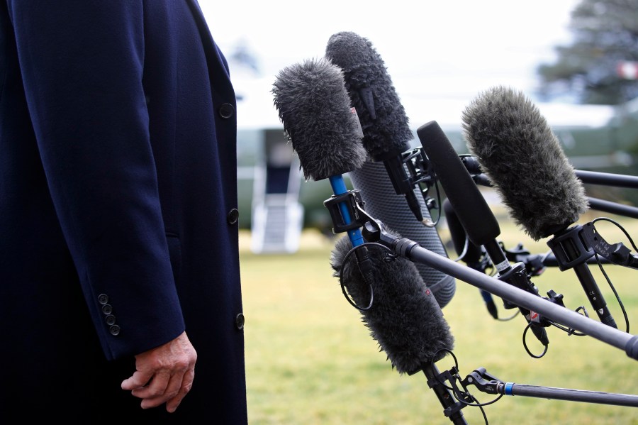 FILE - President Donald Trump stands in front of microphones as he speaks to members of the media on the South Lawn of the White House in Washington, Friday, Feb. 7, 2020, before boarding Marine One. Nearly three-quarters of U.S. adults say the news media is increasing political polarization in this country, and just under half say they have little to no trust in the media's ability to report the news fairly and accurately, according to a new survey from The Associated Press-NORC Center for Public Affairs Research and Robert F. Kennedy Human Rights. (AP Photo/Patrick Semansky, File)