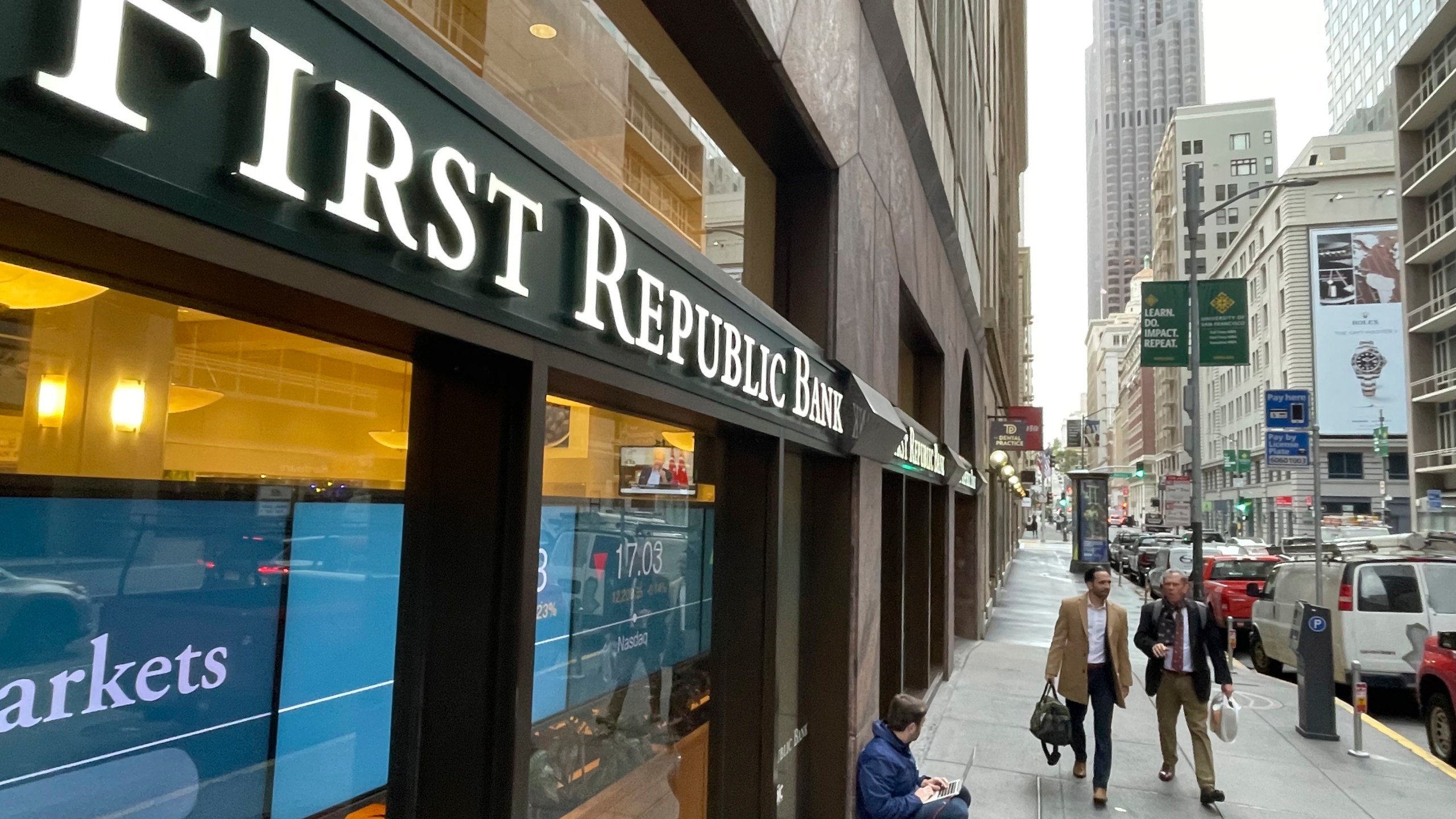 People walk past the headquarters of First Republic Bank in San Francisco, Monday, May 1, 2023. Regulators seized troubled First Republic Bank early Monday, making it the second-largest bank failure in U.S. history, and promptly sold all of its deposits and most of its assets to JPMorgan Chase Bank in a bid to head off further banking turmoil in the U.S. (AP Photo/Haven Daley)