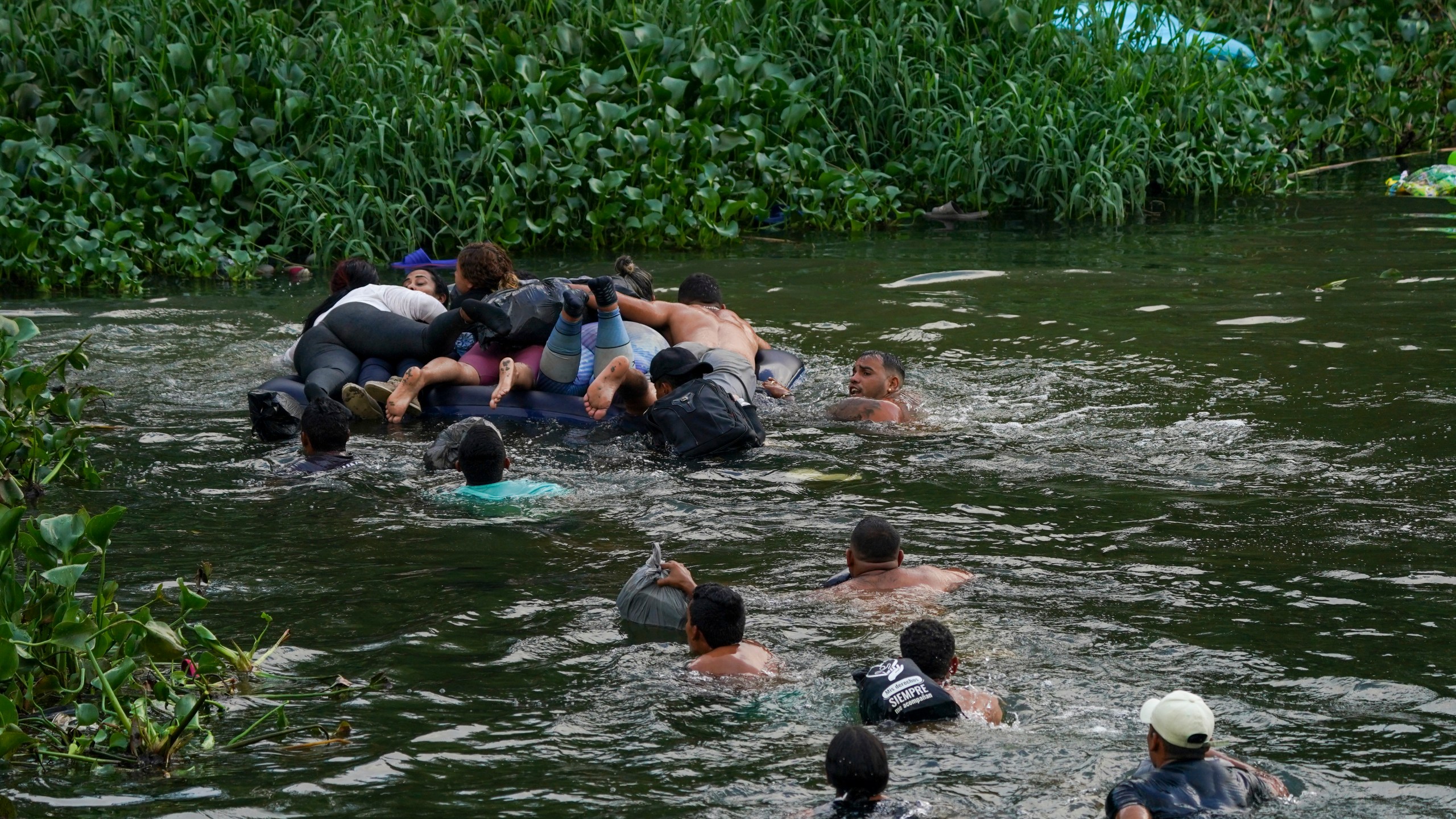 Migrants cross the Rio Bravo into the United States from Matamoros, Mexico, Tuesday, May 9, 2023. The U.S. is preparing for the Thursday, May 11th end of the Title 42 policy, linked to the coronavirus pandemic that allowed it to quickly expel many migrants seeking asylum. (AP Photo/Fernando Llano)