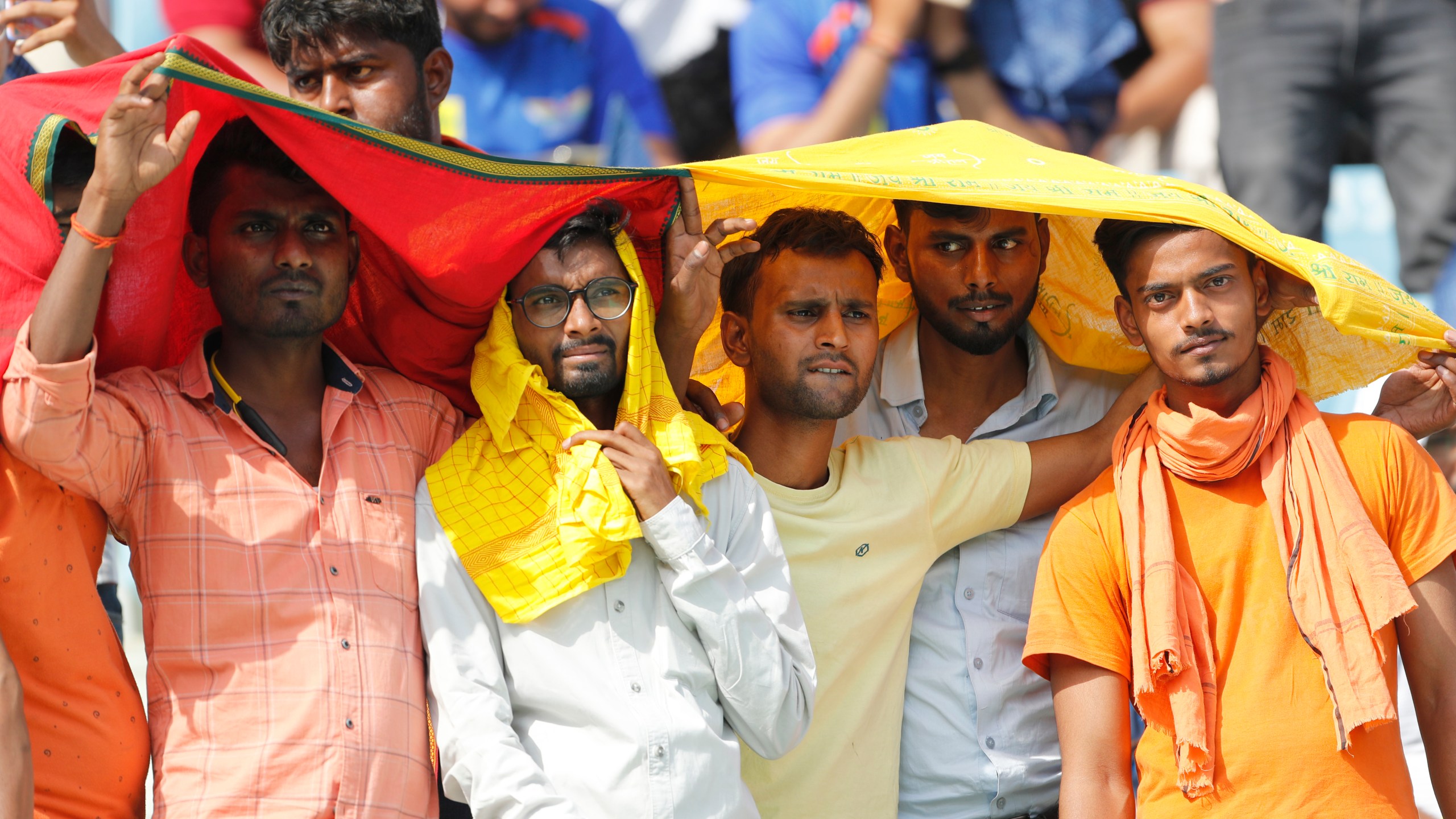 FILE - Cricket fans cover their heads with a long scarf to shield themselves from heat during an Indian Premier League (IPL) cricket match in Lucknow, India, April 22, 2023. A searing heat wave in parts of southern Asia in April this year was made at least 30 times more likely by climate change, according to a rapid study by international scientists released Wednesday, May 17. (AP Photo/Surjeet Yadav, File)