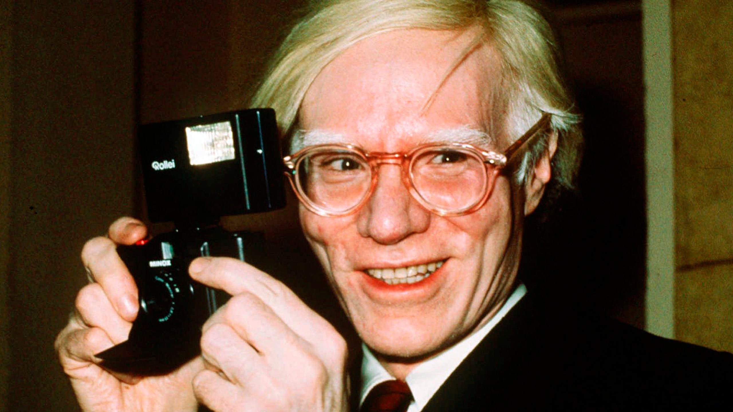 FILE - In this 1976 file photo, pop artist Andy Warhol smiles in New York. The Supreme Court on Thursday, May 18, 2023, sided with a photographer who claimed the late Andy Warhol had violated her copyright on a photograph of the singer Prince. The Supreme Court sided 7-2 with photographer Lynn Goldsmith. The case involved images Warhol created of Prince as part of a 1984 commission for Vanity Fair. Warhol used a Goldsmith photograph as his starting point. (AP Photo/Richard Drew, File)