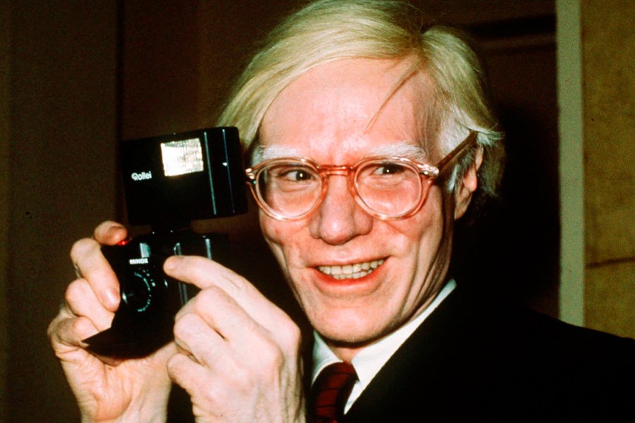 FILE - In this 1976 file photo, pop artist Andy Warhol smiles in New York. The Supreme Court on Thursday, May 18, 2023, sided with a photographer who claimed the late Andy Warhol had violated her copyright on a photograph of the singer Prince. The Supreme Court sided 7-2 with photographer Lynn Goldsmith. The case involved images Warhol created of Prince as part of a 1984 commission for Vanity Fair. Warhol used a Goldsmith photograph as his starting point. (AP Photo/Richard Drew, File)