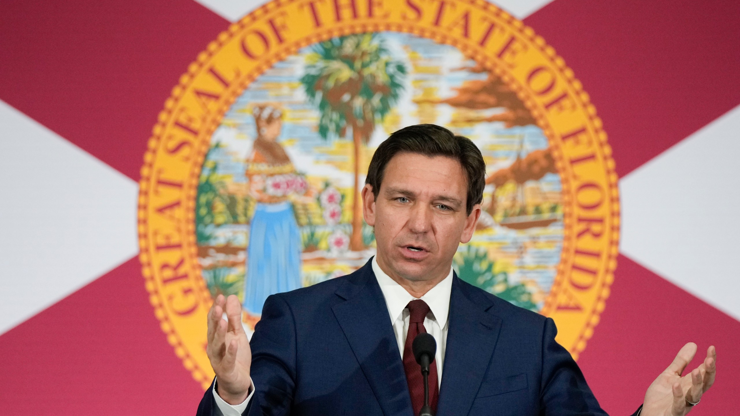 FILE - Florida Gov. Ron DeSantis speaks during a news conference in Miami, Tuesday, May 9, 2023. Videos circulating on social media purport to show empty Florida grocery stores due to a boycott of truck drivers over an immigration bill recently signed by DeSantis. However, while some truckers have threatened to stop deliveries in the state, these grocery aisles are empty for reasons that are unrelated to the recent bill. (AP Photo/Rebecca Blackwell, File)