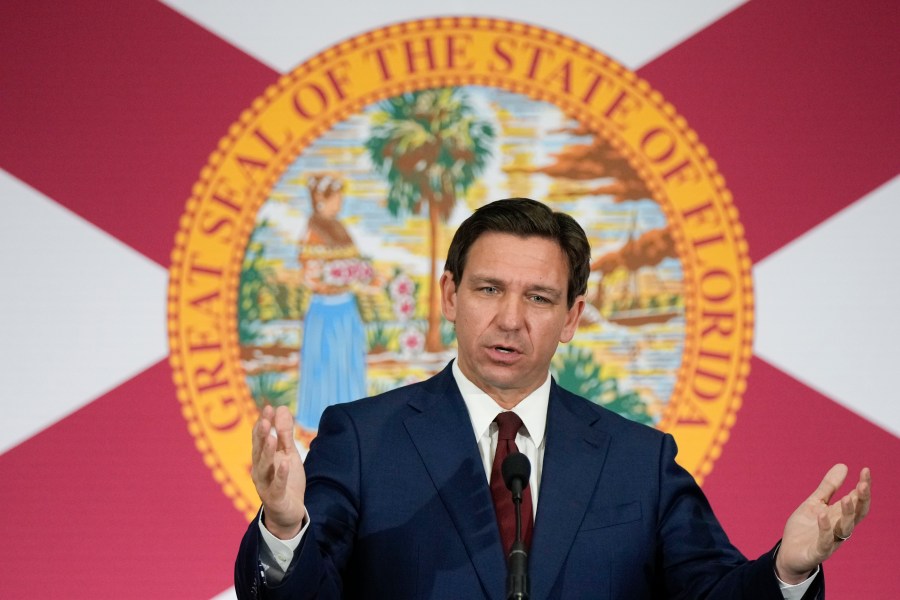 FILE - Florida Gov. Ron DeSantis speaks during a news conference in Miami, Tuesday, May 9, 2023. Videos circulating on social media purport to show empty Florida grocery stores due to a boycott of truck drivers over an immigration bill recently signed by DeSantis. However, while some truckers have threatened to stop deliveries in the state, these grocery aisles are empty for reasons that are unrelated to the recent bill. (AP Photo/Rebecca Blackwell, File)