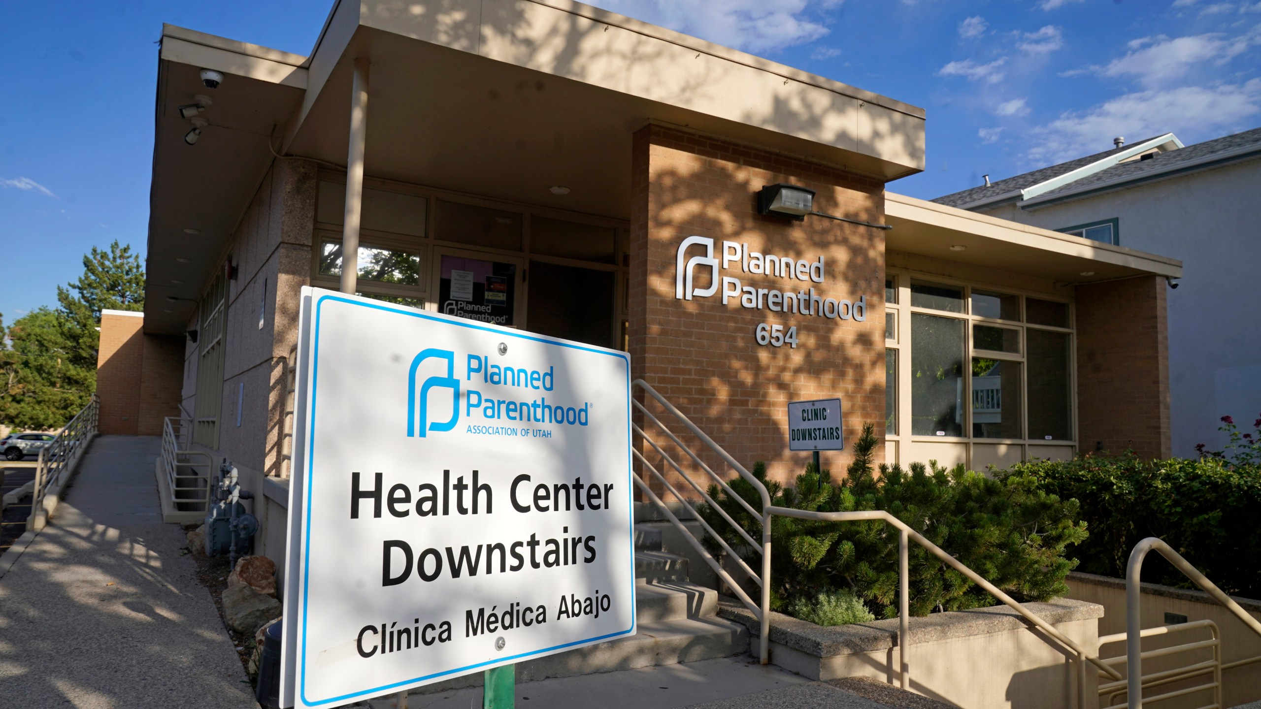 FILE - A sign stands outside Planned Parenthood of Utah on June 28, 2022, in Salt Lake City. Planned Parenthood is shifting funding to its state affiliates and cutting national office staff to reflect a changed landscape in both how abortion is provided and how battles over access are playing out. The group, a major provider of abortion and other health services and also an advocate for abortion access, told its staff on Monday, May 22, 2023, that layoff notices would go out in June and provided The Associated Press with an overview Tuesday. (AP Photo/Rick Bowmer, File)