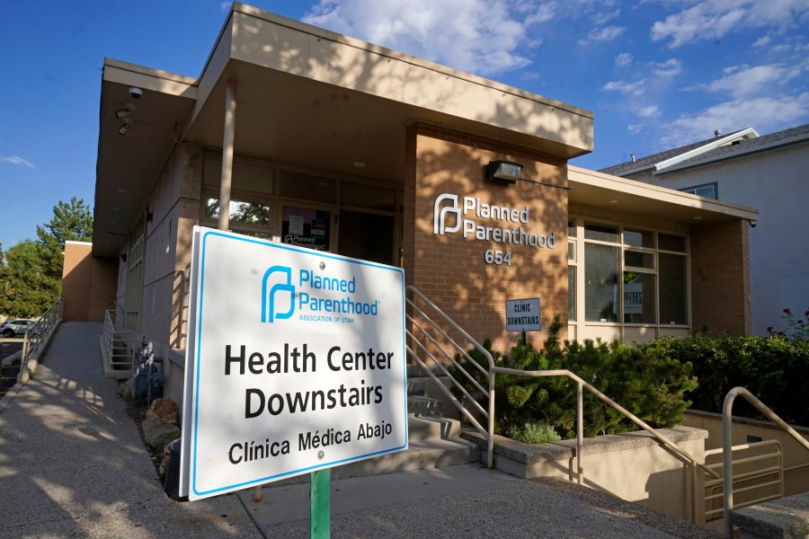 FILE - A sign stands outside Planned Parenthood of Utah on June 28, 2022, in Salt Lake City. Planned Parenthood is shifting funding to its state affiliates and cutting national office staff to reflect a changed landscape in both how abortion is provided and how battles over access are playing out. The group, a major provider of abortion and other health services and also an advocate for abortion access, told its staff on Monday, May 22, 2023, that layoff notices would go out in June and provided The Associated Press with an overview Tuesday. (AP Photo/Rick Bowmer, File)