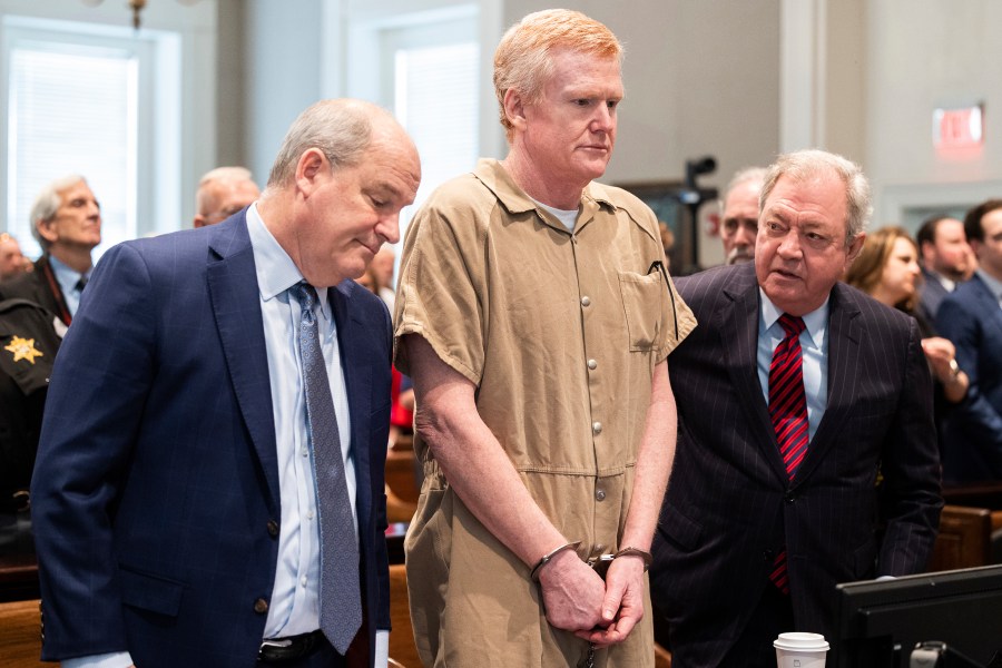 FILE - Alex Murdaugh speaks with his legal team before he is sentenced to two consecutive life sentences for the murder of his wife and son by Judge Clifton Newman at the Colleton County Courthouse on Friday, March 3, 2023 in in Walterboro, S.C. Convicted murderer Murdaugh is facing federal charges for the first time after being indicted on 22 financial fraud charges related to schemes the former attorney used to steal settlement money from clients. (Joshua Boucher/The State via AP, Pool, File)