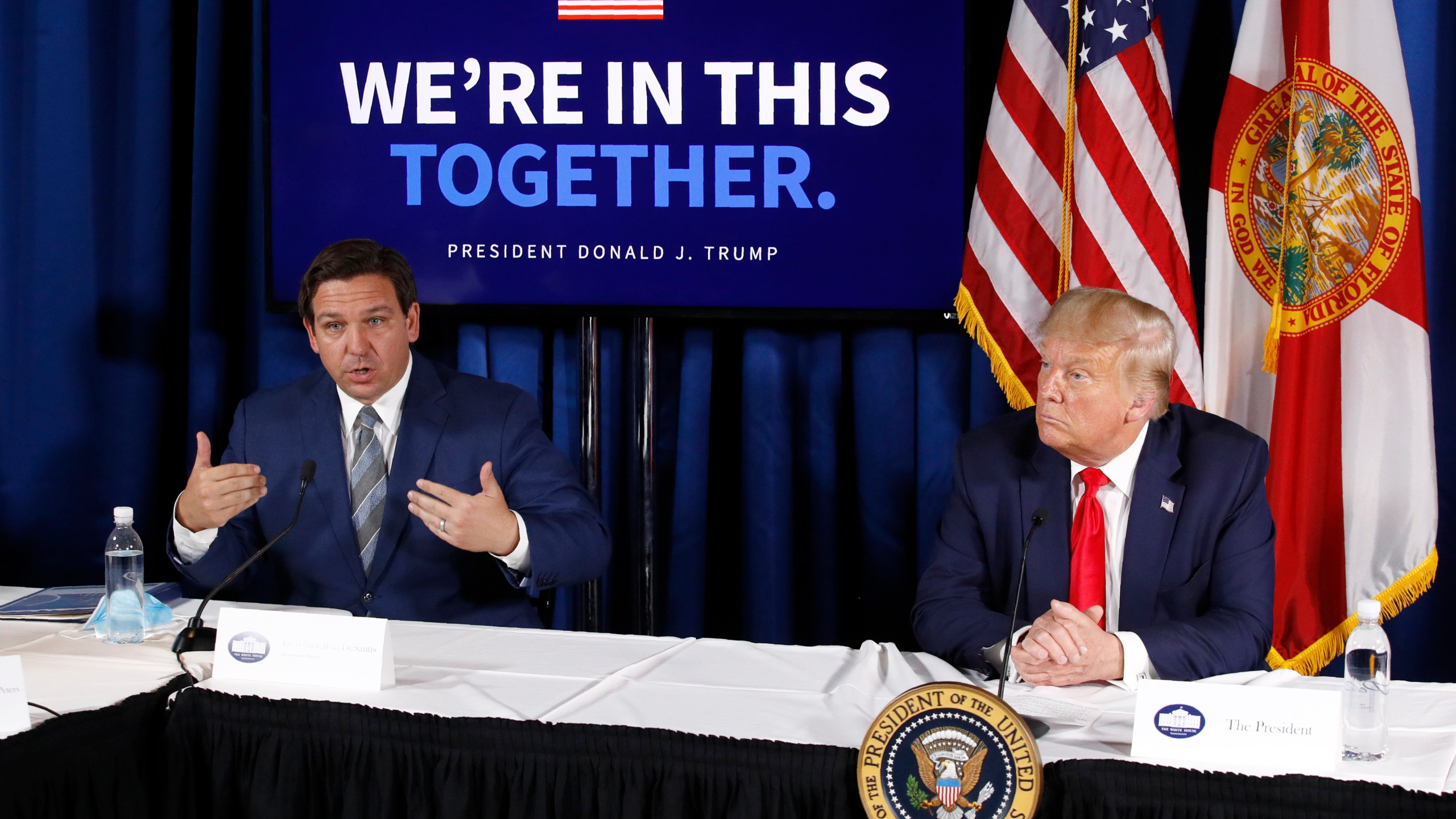 FILE - Florida Gov. Ron DeSantis, left, speaks alongside President Donald Trump during a roundtable discussion on the coronavirus outbreak and storm preparedness at Pelican Golf Club in Belleair, Fla., July 31, 2020. Before Trump and DeSantis were leading rivals for the 2024 Republican presidential nomination, they were allies. (AP Photo/Patrick Semansky, File)