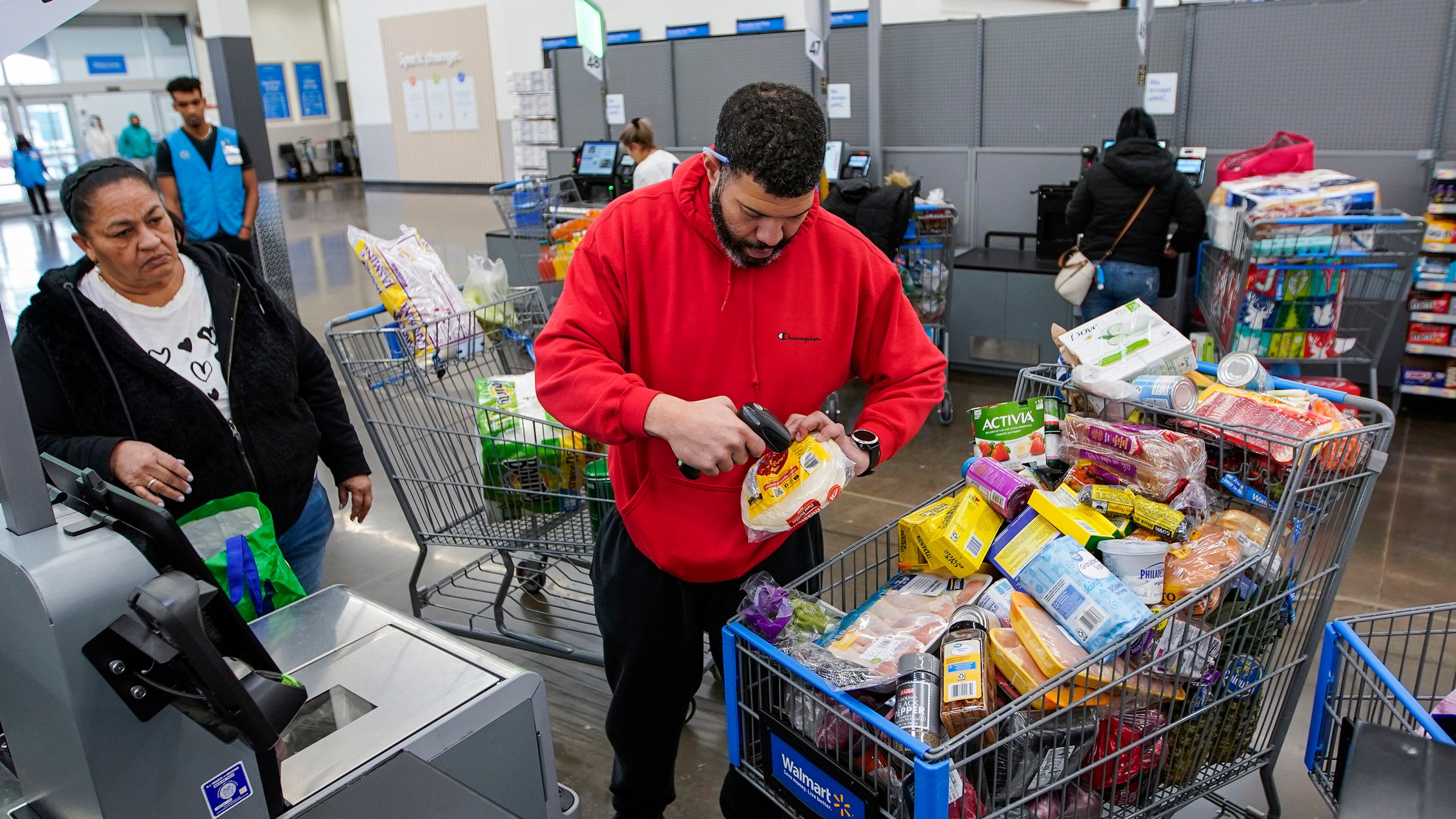 File - Francisco Santana buys groceries at the Walmart Supercenter in North Bergen, N.J. on Thursday, Feb. 9, 2023. On Friday, the Commerce Department issues its April report on consumer spending. (AP Photo/Eduardo Munoz Alvarez, File)