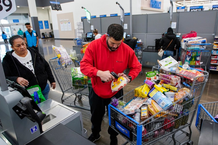 File - Francisco Santana buys groceries at the Walmart Supercenter in North Bergen, N.J. on Thursday, Feb. 9, 2023. On Friday, the Commerce Department issues its April report on consumer spending. (AP Photo/Eduardo Munoz Alvarez, File)