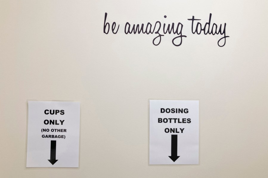 FILE - Signs at a drug treatment center show where receptacles used to dispense methadone should be disposed of after use on Feb. 24, 2022, in Salem, Ore. Oregon's pioneering drug decriminalization program, which allocates vast resources to rehabilitate drug abusers, has for the first time terminated funding for a service provider amid missed financial reporting deadlines and alleged misspending. (AP Photo/Andrew Selsky, File)