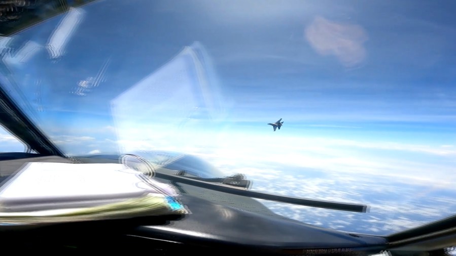 In this image from video provided by the U.S. Navy, a Chinese J-16 fighter flys aggressively close to a U.S. RC-135 aircraft flying in international airspace over the South China Sea on Friday, May 26, 2023. In a statement, U.S. Indo-Pacific Command said the Chinese J-16 fighter pilot "flew directly in front of the nose of the RC-135." It called the Chinese move an " unnecessarily aggressive maneuver." (U.S. Navy via AP)