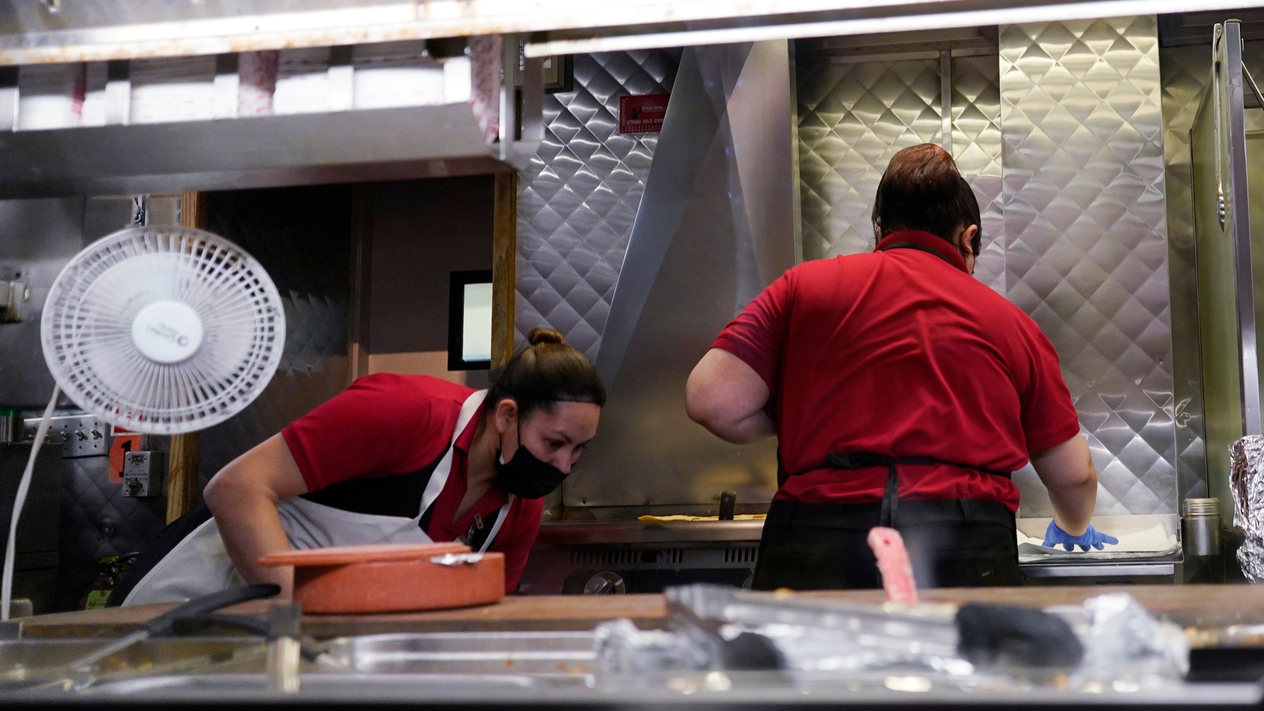 File - Women work in a restaurant kitchen in Chicago, Thursday, March 23, 2023. On Friday, the U.S. government issues the May jobs report. The labor market has added jobs at a steady clip in the past year, despite efforts by the Federal Reserve to cool the economy and bring down inflation. (AP Photo/Nam Y. Huh, File)