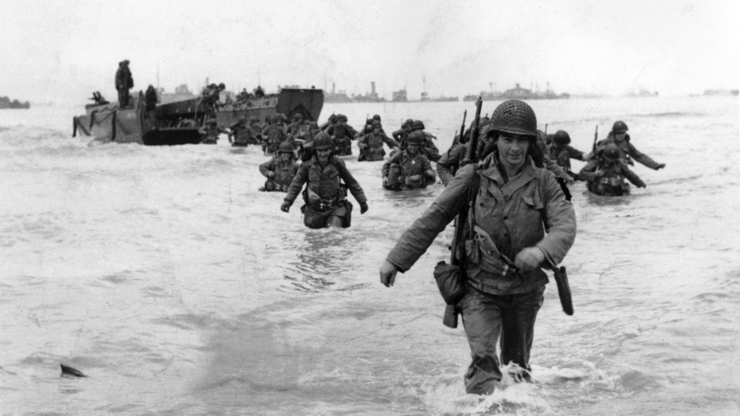 FILE - U.S. infantrymen wade through the surf as they land at Normandy in the days following the Allies' June 1944, D-Day invasion of occupied France. (AP Photo/Bert Brandt, File)