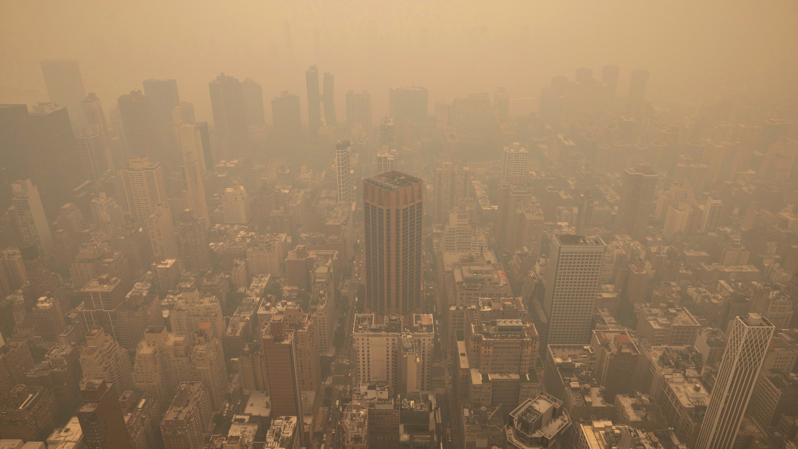 An aerial view shows New York City in a haze-filled sky from the Empire State Building observatory, Wednesday, June. 7, 2023, in New York. Smoke from Canadian wildfires poured into the U.S. East Coast and Midwest on Wednesday, covering cities of both nations in an unhealthy haze, holding up flights at major airports and prompting people to fish out pandemic-era face masks. (AP Photo/Yuki Iwamura)