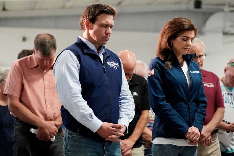 FILE - Republican presidential candidate Florida Gov. Ron DeSantis and his wife, Casey, bow their heads during a prayer at a campaign event, Wednesday, May 31, 2023, in Cedar Rapids, Iowa. (AP Photo/Charlie Neibergall, File)