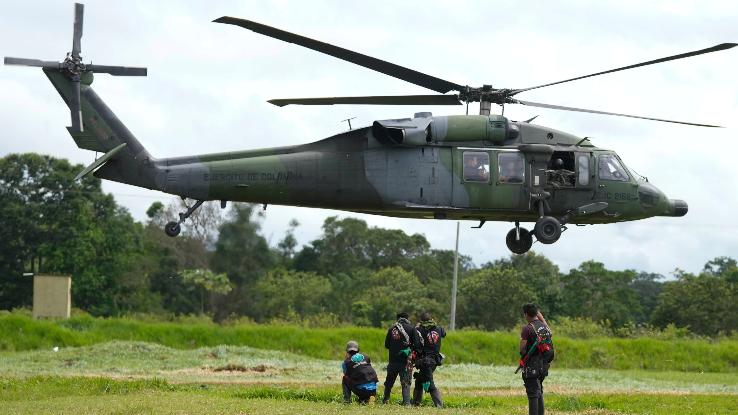 A military helicopter takes off with a group of Indigenous at a military base in Calamar, Colombia, Tuesday, May 23, 2023, to help search for four Indigenous children who are missing after a deadly plane crash. The May 30 discovery of footprints of a small foot rekindled the hope of finding the children alive after their plane crashed on May 1. Soldiers found the wreckage and the bodies of three adults, including the pilot and the children's mother. (AP Photo/Fernando Vergara)