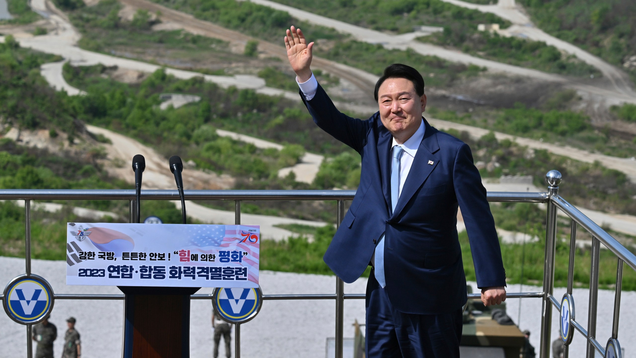 South Korean President Yoon Suk Yeol waves as he delivers a speech after a South Korea-U.S. joint military drill at Seungjin Fire Training Field in Pocheon, South Korea Thursday, June 15, 2023. (Jung Yeon-je/Pool Photo via AP)