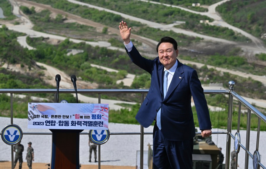 South Korean President Yoon Suk Yeol waves as he delivers a speech after a South Korea-U.S. joint military drill at Seungjin Fire Training Field in Pocheon, South Korea Thursday, June 15, 2023. (Jung Yeon-je/Pool Photo via AP)