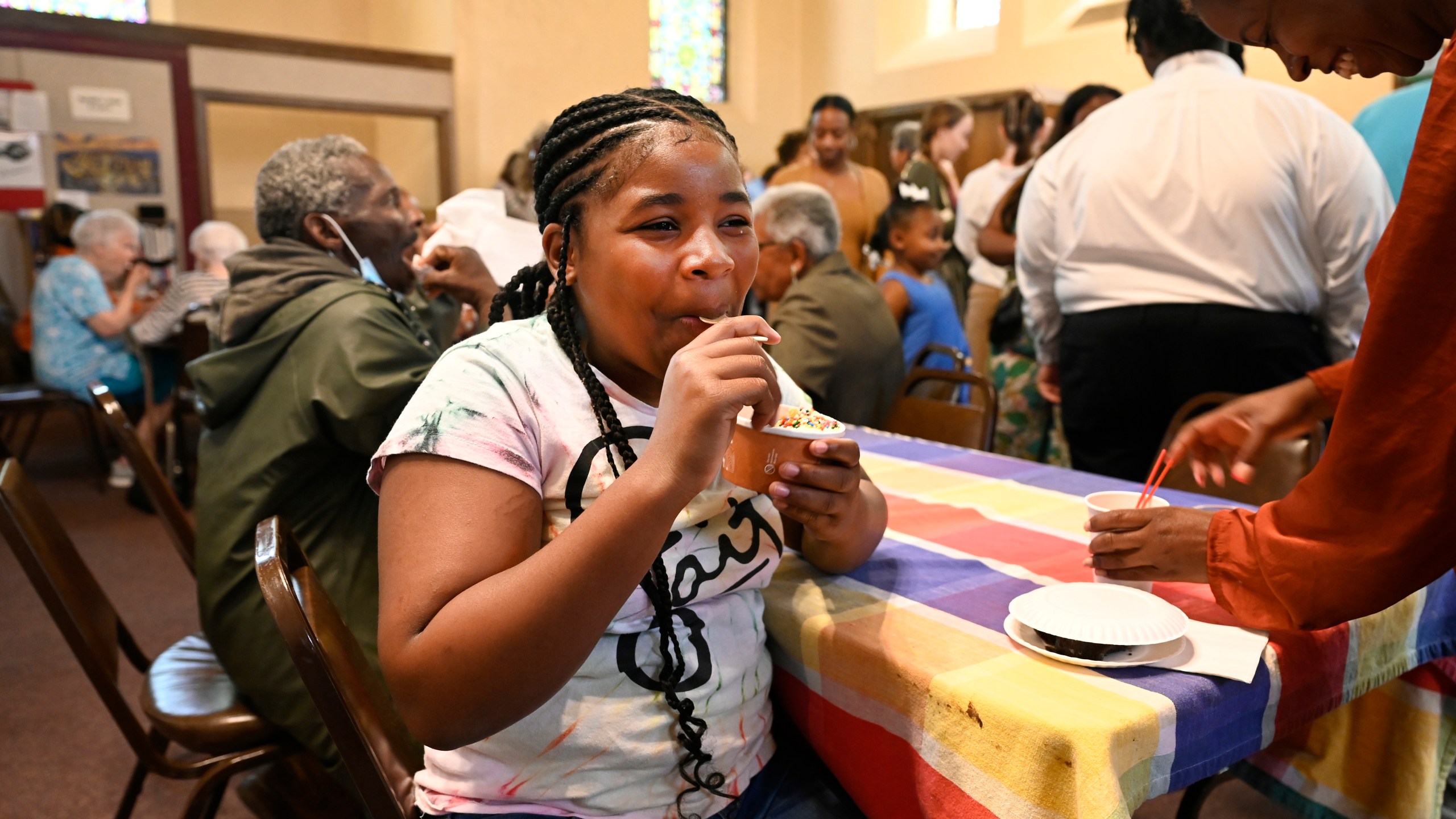 A'lelia Johnson, 12, of Detroit, enjoys ice cream during a social gathering after Mass concluded, Sunday, June 18, 2023, at Gesu Catholic Church in Detroit. (AP Photo/Jose Juarez)